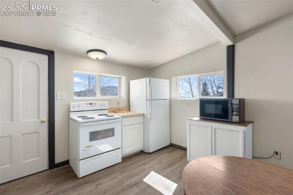 112 6th Street Victor, CO 80860 - Photo 22 of 35 a kitchen with stainless steel appliances a stove microwave and refrigerator