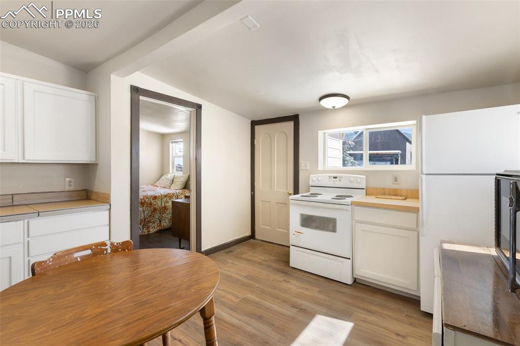 112 6th Street Victor, CO 80860 - Photo 24 of 35 a kitchen with a stove a refrigerator and a stove top oven