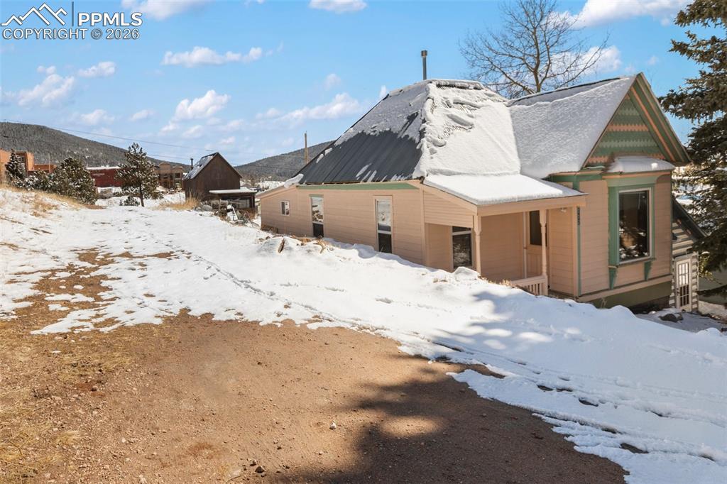 112 6th Street Victor, CO 80860 - Photo 29 of 35 a view of a house with a snow in the yard