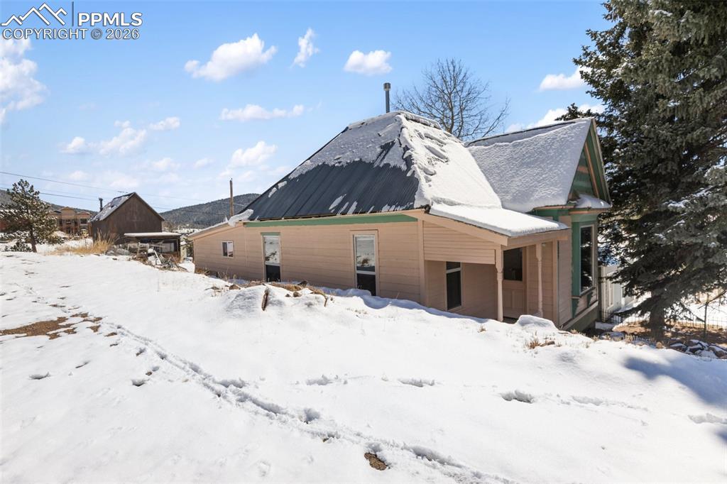 112 6th Street Victor, CO 80860 - Photo 3 of 35 a view of a white house with snow on the road