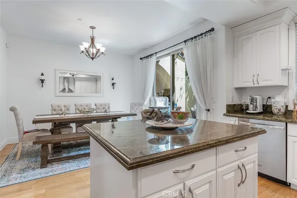 a view of kitchen island a sink and a stove