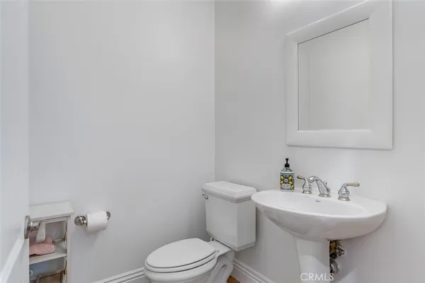a bathroom with a sink toilet and a mirror