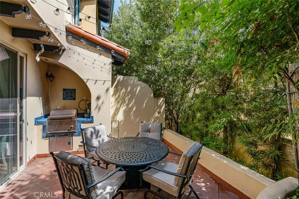 a view of backyard with seating space and trees