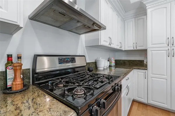 a stove top oven sitting inside of a kitchen