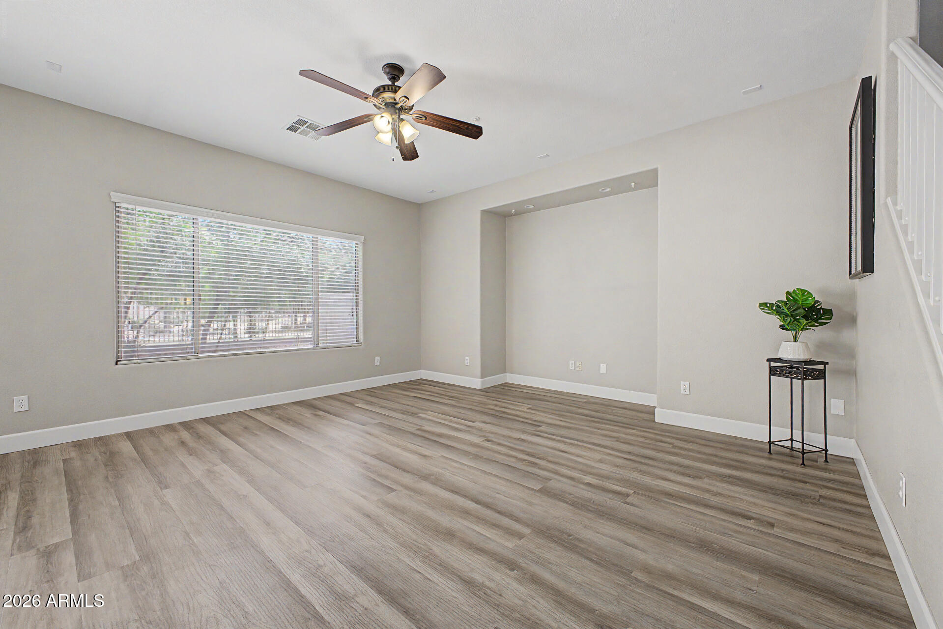 1379 East Joseph Way Gilbert, AZ 85295 - Photo 11 of 44 a view of an empty room with wooden floor and a window