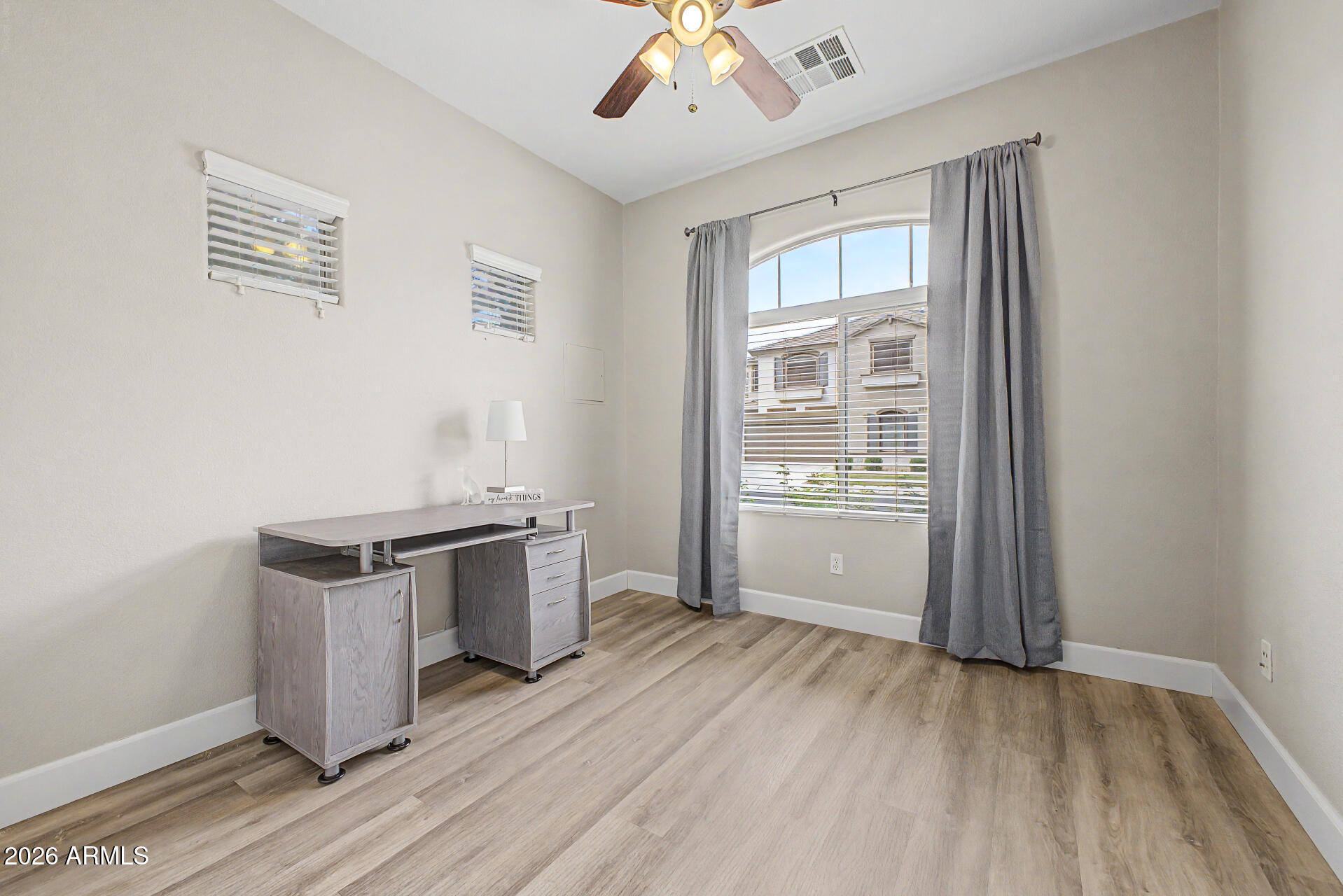 1379 East Joseph Way Gilbert, AZ 85295 - Photo 13 of 44 an empty room with wooden floor cabinet and windows