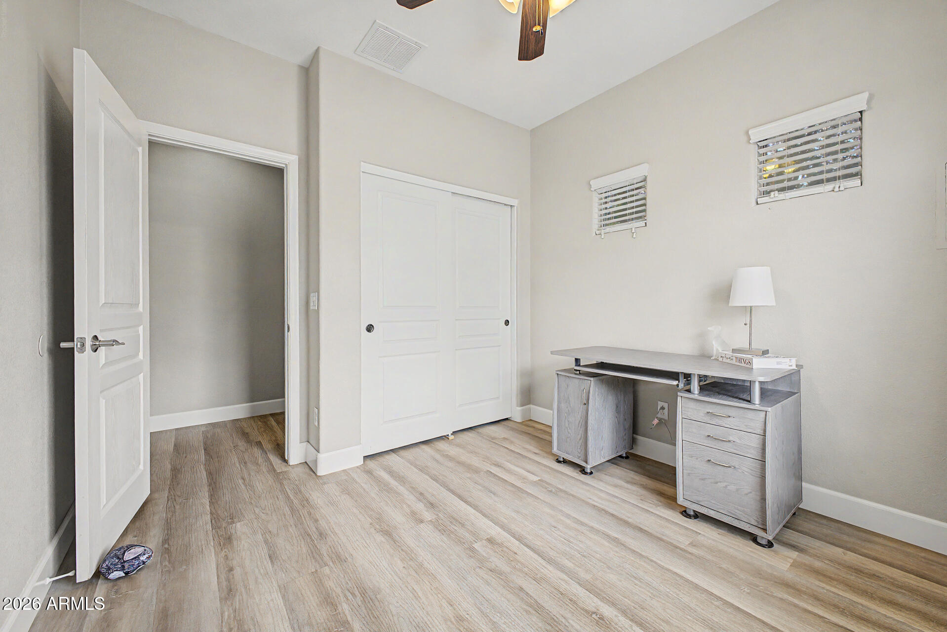 1379 East Joseph Way Gilbert, AZ 85295 - Photo 14 of 44 an empty room with wooden floor cabinet and a ceiling fan