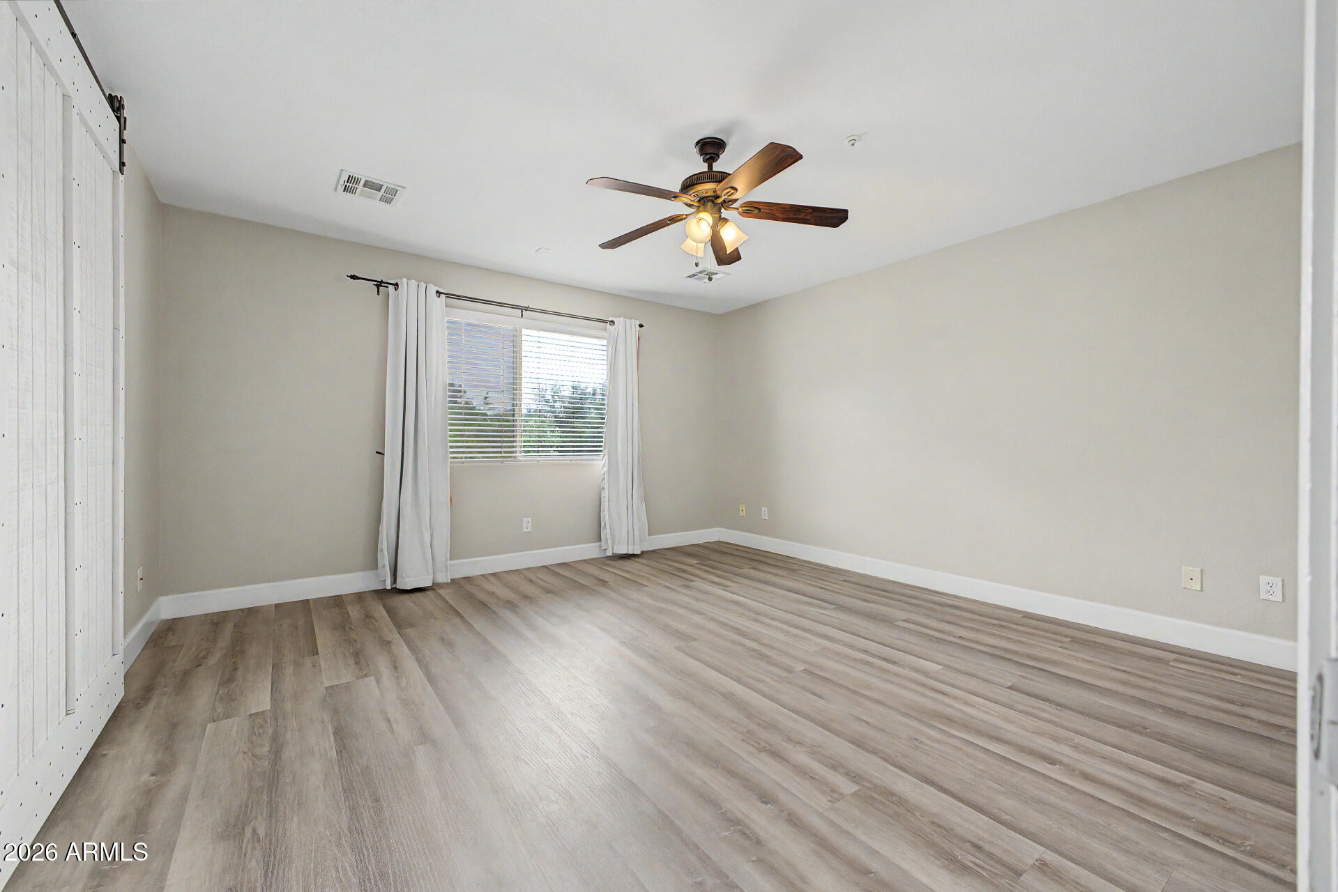 1379 East Joseph Way Gilbert, AZ 85295 - Photo 16 of 44 wooden floor in an empty room with a window