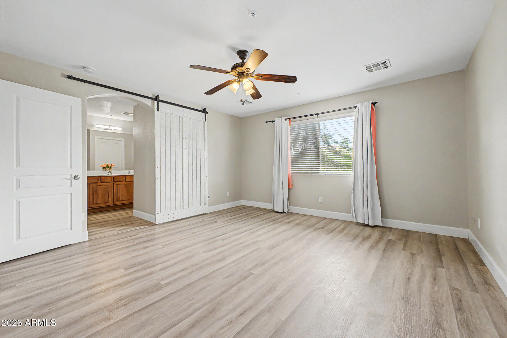 1379 East Joseph Way Gilbert, AZ 85295 - Photo 17 of 44 an empty room with wooden floor ceiling fan and windows