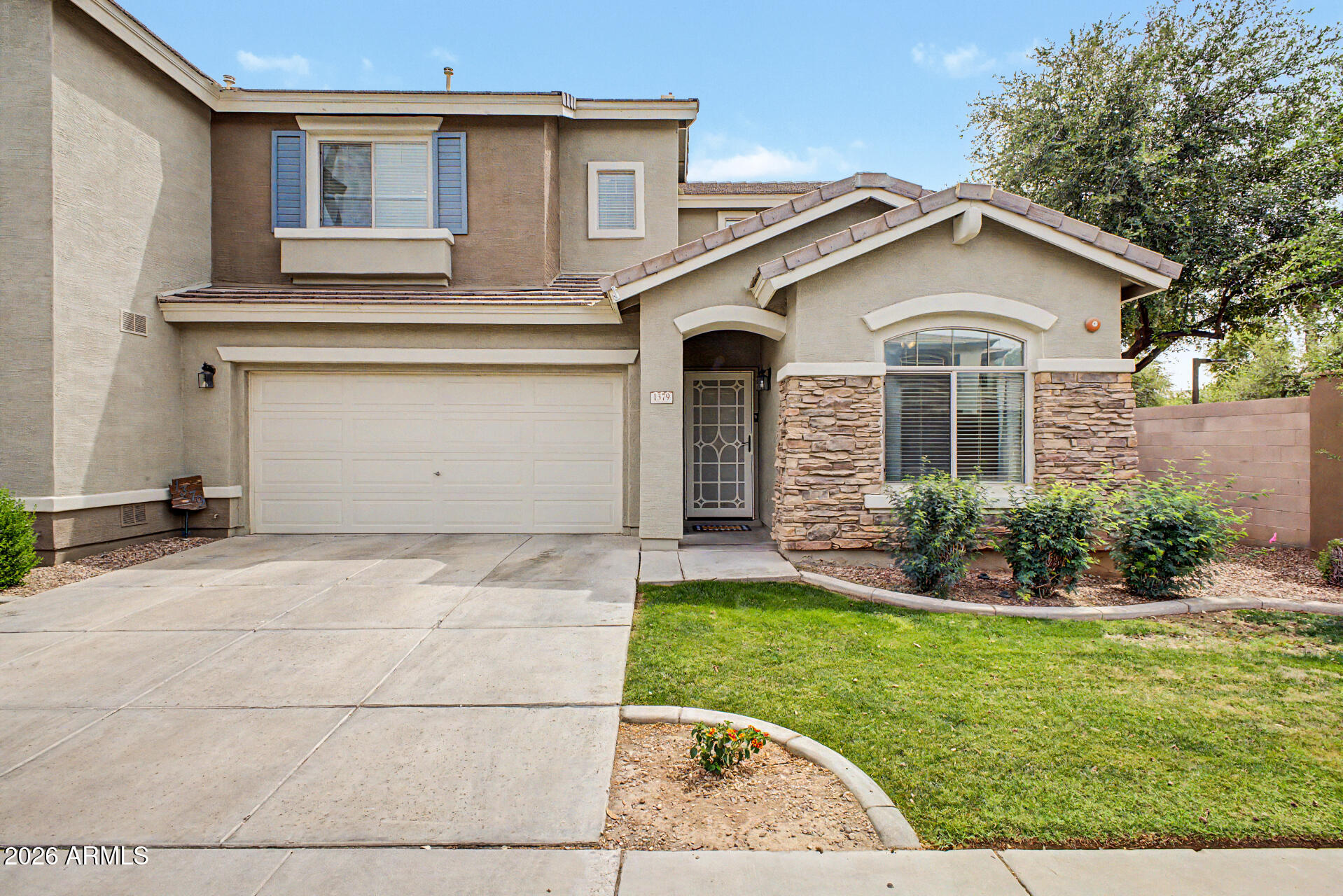 1379 East Joseph Way Gilbert, AZ 85295 - Photo 3 of 44 a front view of a house with a yard