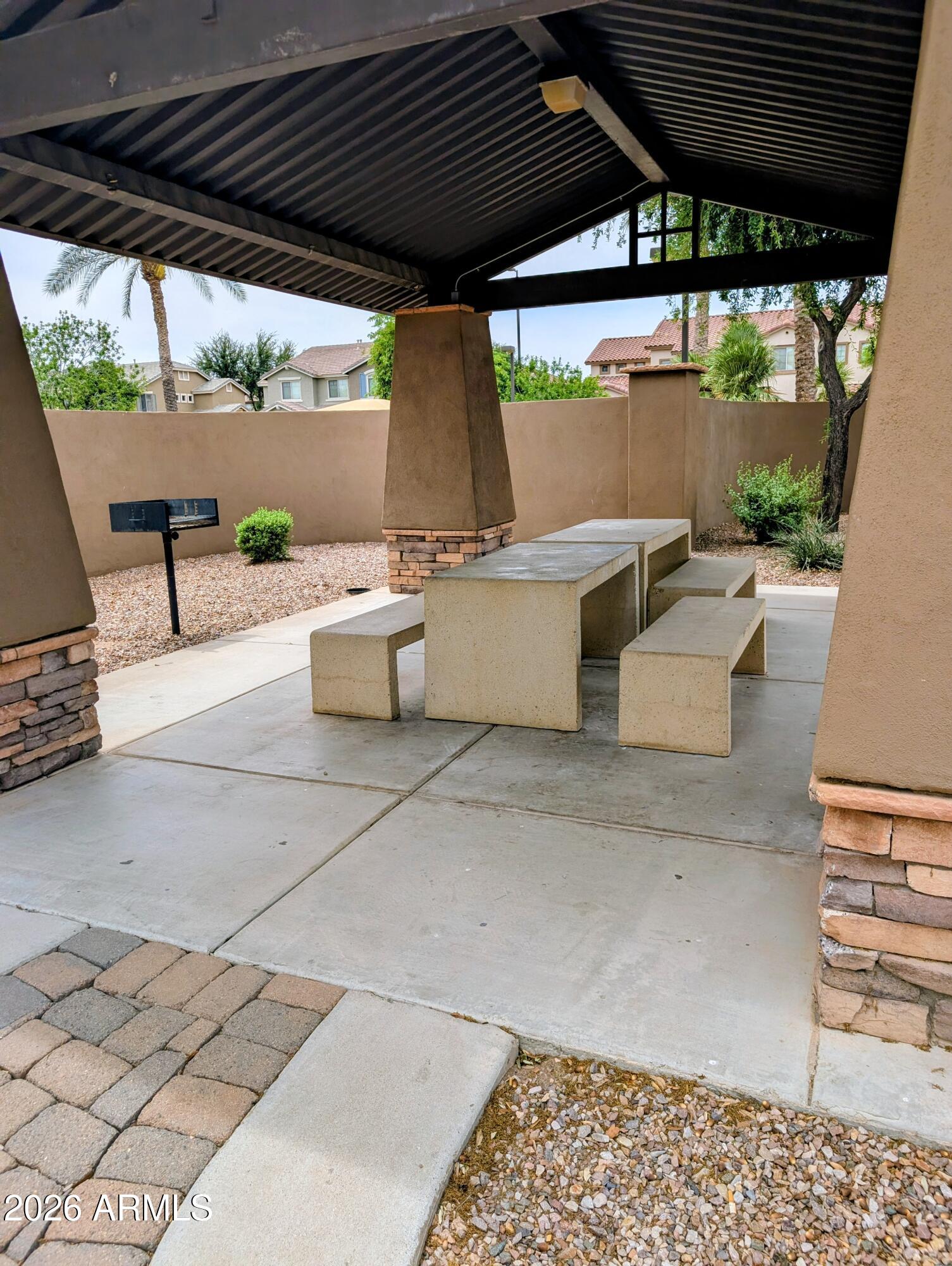 1379 East Joseph Way Gilbert, AZ 85295 - Photo 37 of 44 a view of a patio with a table and chairs under an umbrella with a barbeque