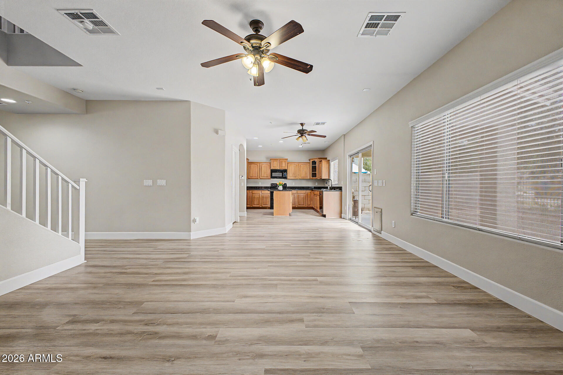 1379 East Joseph Way Gilbert, AZ 85295 - Photo 5 of 44 a view of a room with wooden floor and a ceiling fan