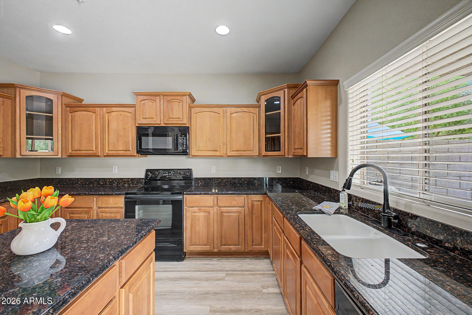 1379 East Joseph Way Gilbert, AZ 85295 - Photo 7 of 44 a kitchen with granite countertop a sink stove and cabinets