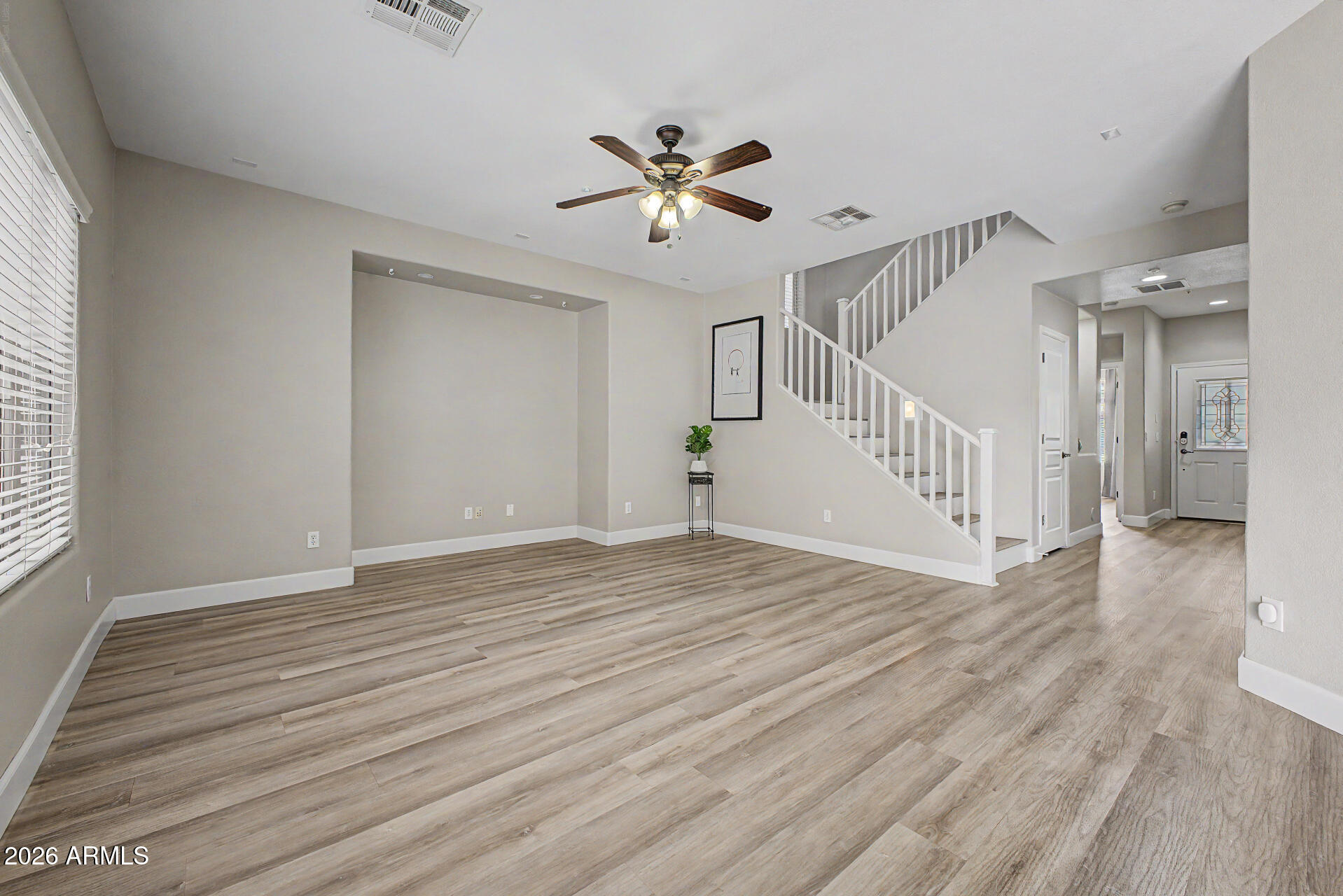 1379 East Joseph Way Gilbert, AZ 85295 - Photo 10 of 44 a view of an empty room with wooden floor and a window