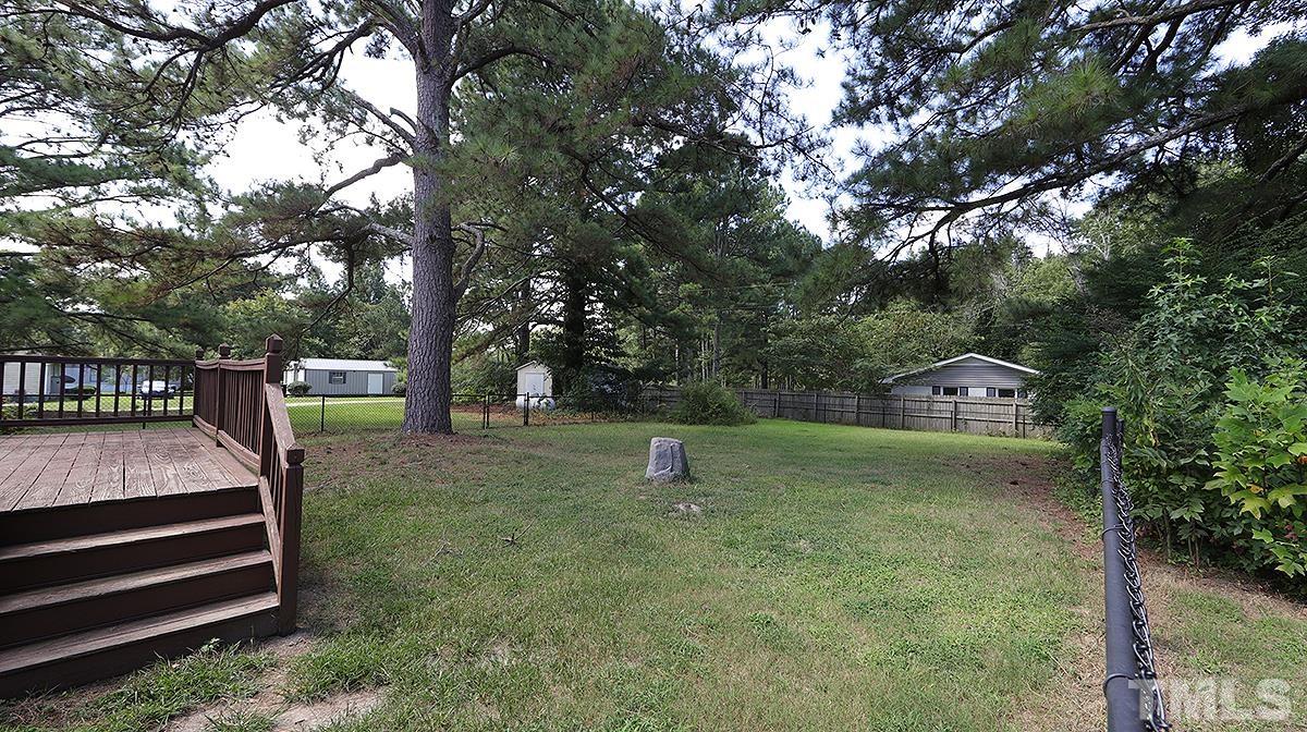 4101 Edgemont Road Wendell, NC 27591 - Photo 11 of 12 a green field with trees in the background