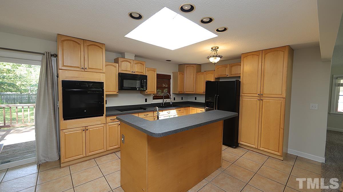 4101 Edgemont Road Wendell, NC 27591 - Photo 2 of 12 a kitchen with cabinets and stainless steel appliances