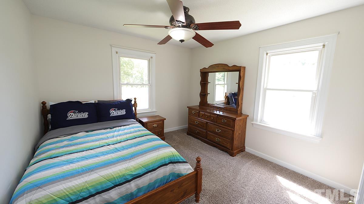 4101 Edgemont Road Wendell, NC 27591 - Photo 7 of 12 a bedroom with a bed and wooden floor