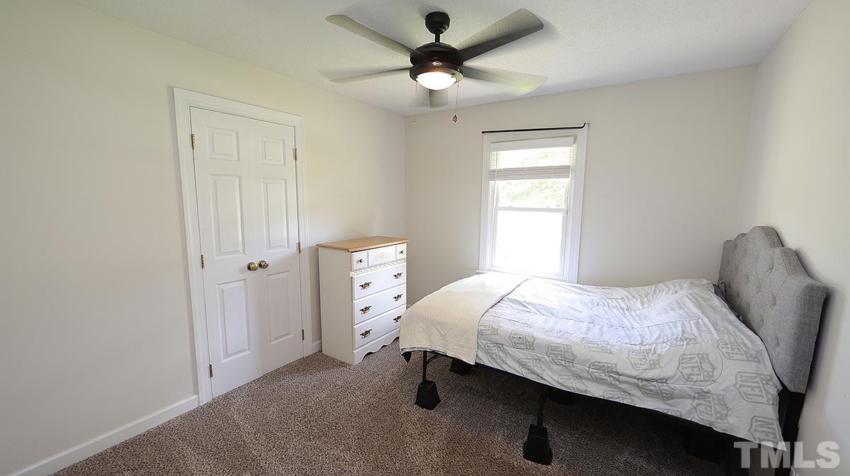 4101 Edgemont Road Wendell, NC 27591 - Photo 9 of 12 a bedroom with a bed and a ceiling fan