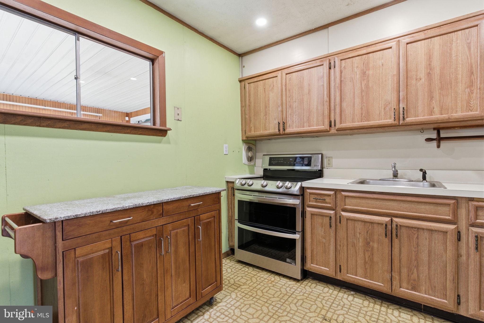 28 Cloister Road Levittown, PA 19057 - Photo 12 of 28 a kitchen with stainless steel appliances granite countertop a stove a sink and a microwave