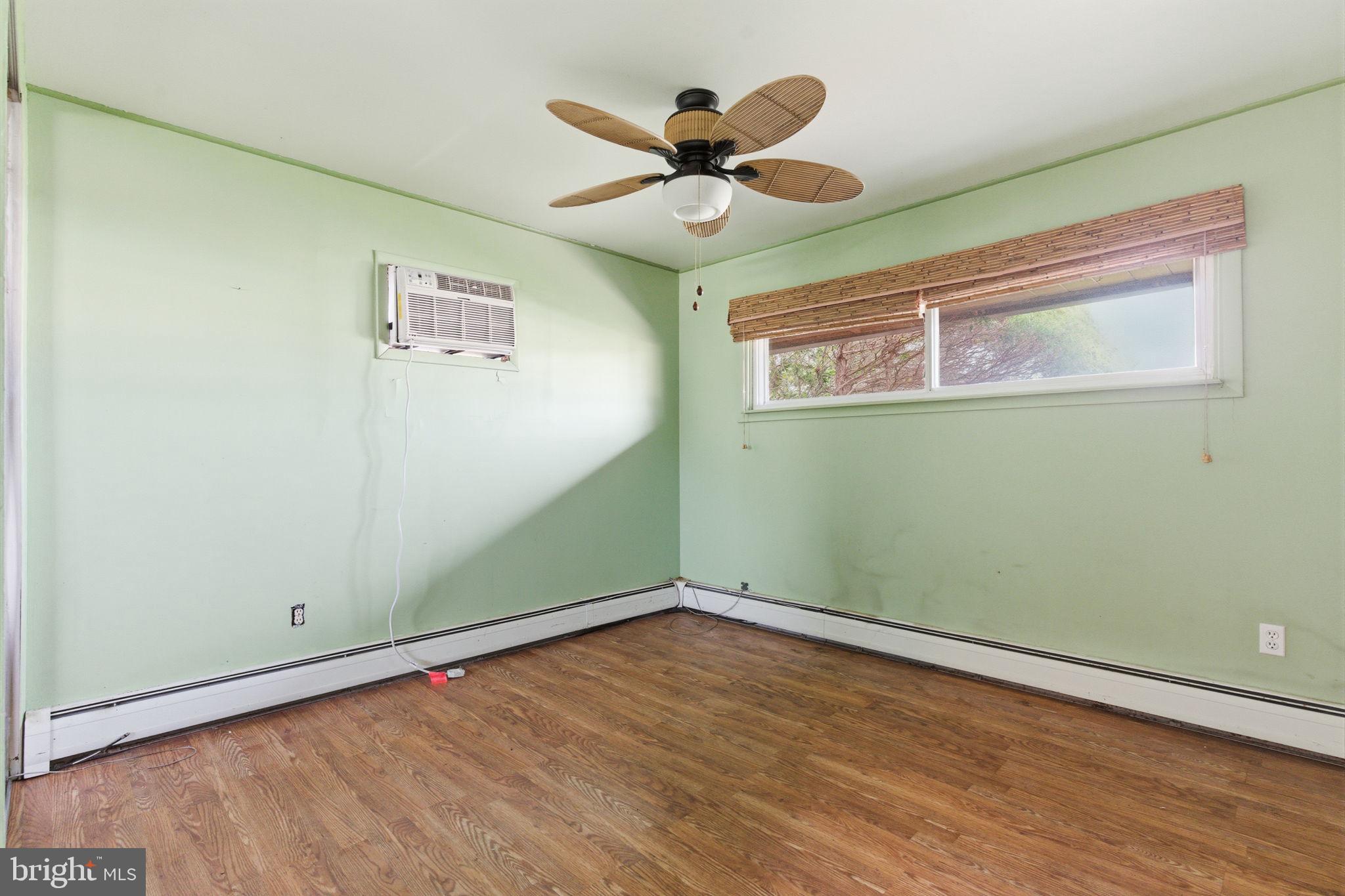 28 Cloister Road Levittown, PA 19057 - Photo 19 of 28 an empty room with wooden floor and ceiling fan