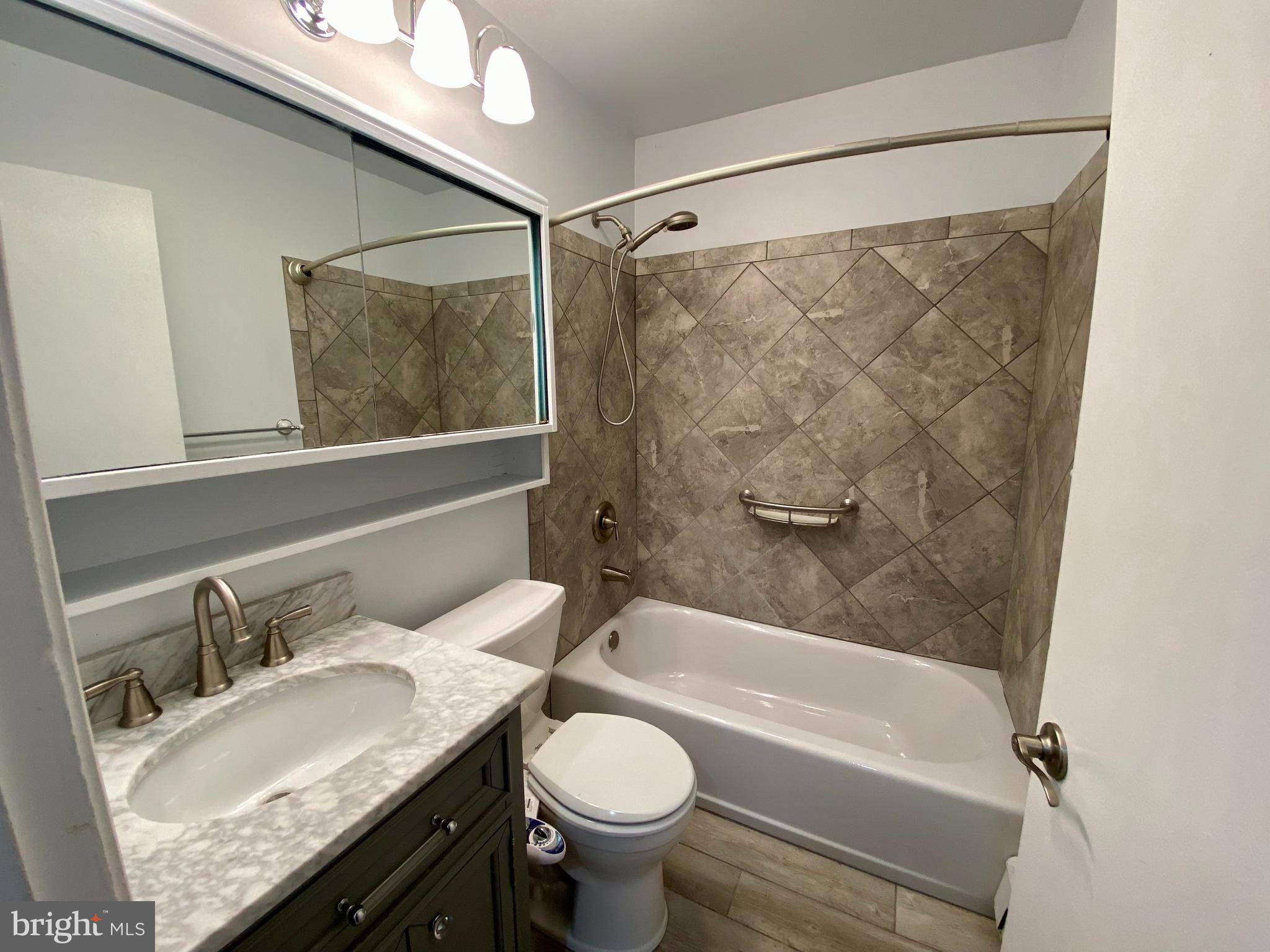 28 Cloister Road Levittown, PA 19057 - Photo 20 of 28 a bathroom with a granite countertop sink toilet and shower