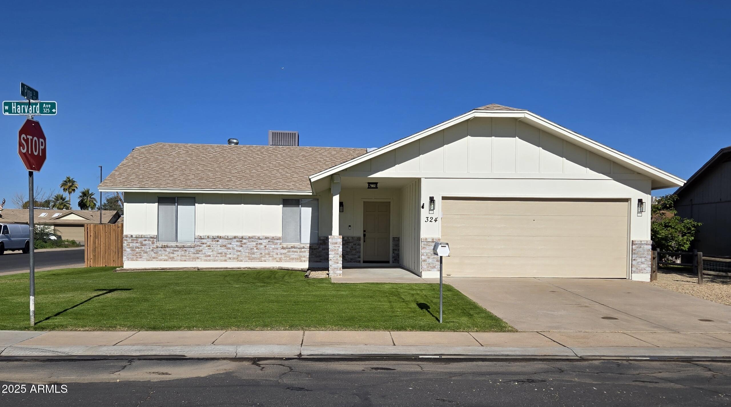 324 West Harvard Avenue Gilbert, AZ 85233 - Photo 1 of 27 a front view of a house with a yard and garage