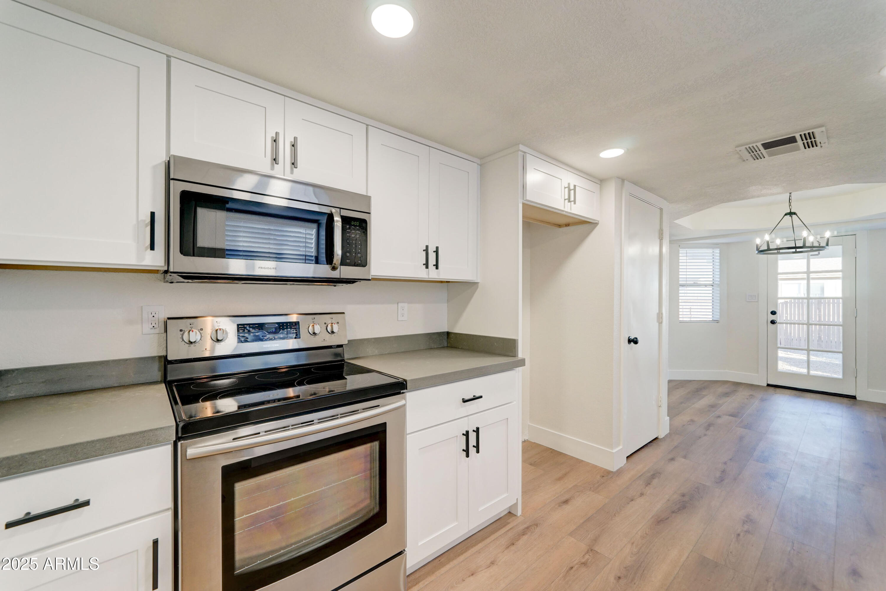 324 West Harvard Avenue Gilbert, AZ 85233 - Photo 11 of 27 a kitchen with stainless steel appliances granite countertop a stove microwave and refrigerator