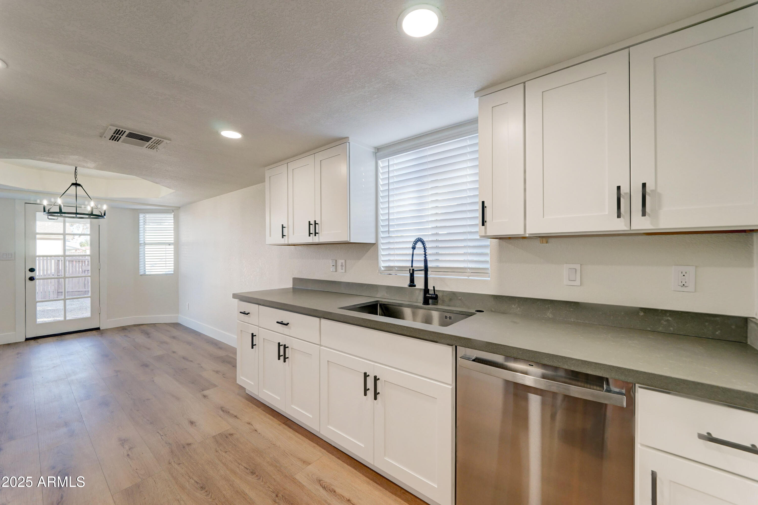 324 West Harvard Avenue Gilbert, AZ 85233 - Photo 12 of 27 a kitchen with granite countertop white cabinets and a sink