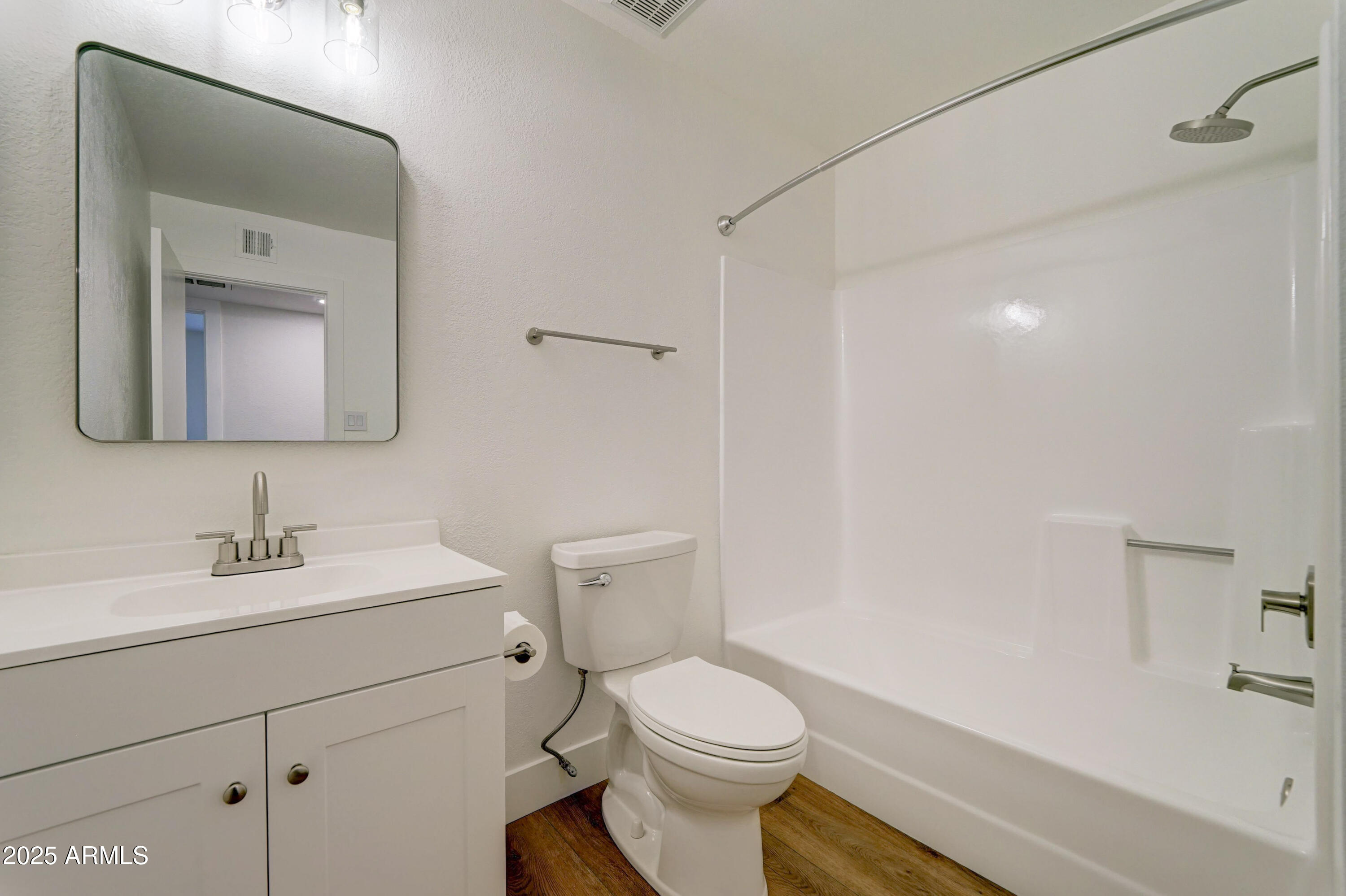 324 West Harvard Avenue Gilbert, AZ 85233 - Photo 21 of 27 a bathroom with a toilet sink vanity and mirror