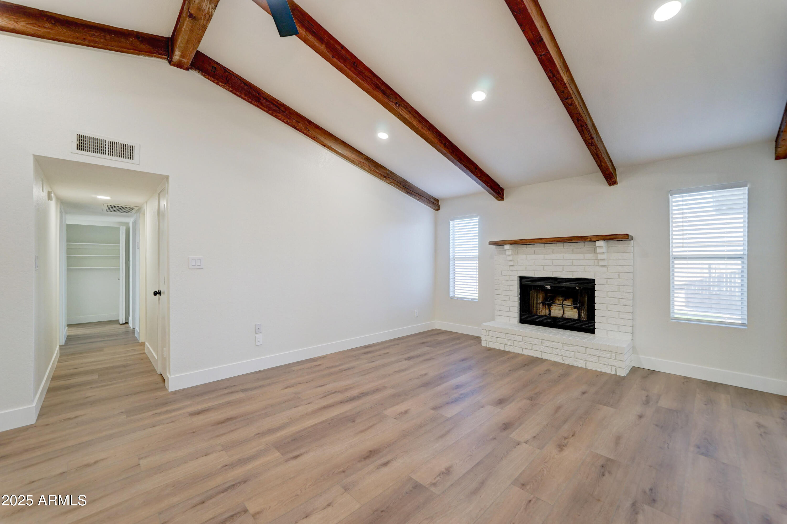 324 West Harvard Avenue Gilbert, AZ 85233 - Photo 7 of 27 a view of an empty room with wooden floor fireplace and a window
