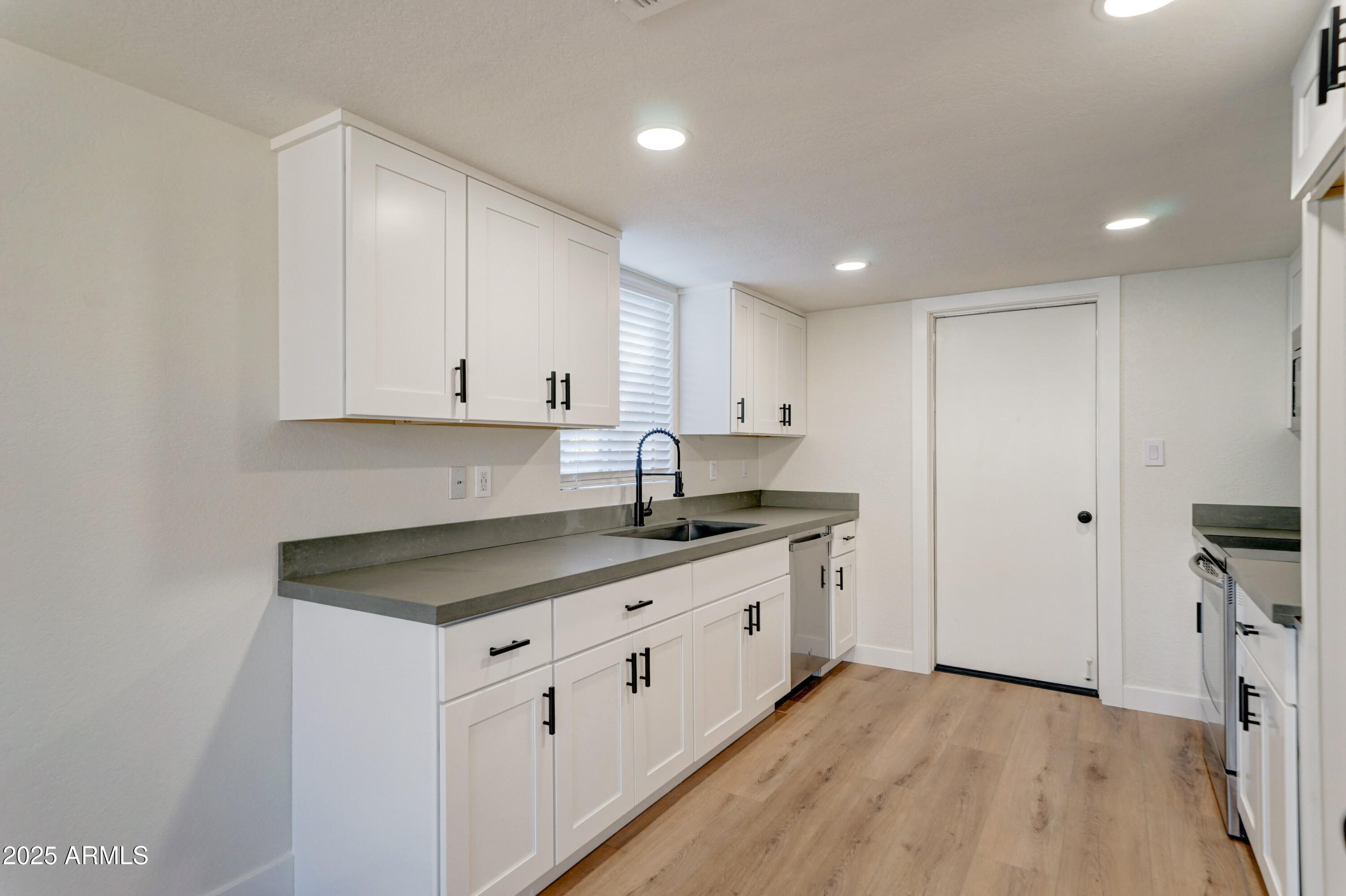 324 West Harvard Avenue Gilbert, AZ 85233 - Photo 9 of 27 a kitchen that has a lot of cabinets in it and wooden floors
