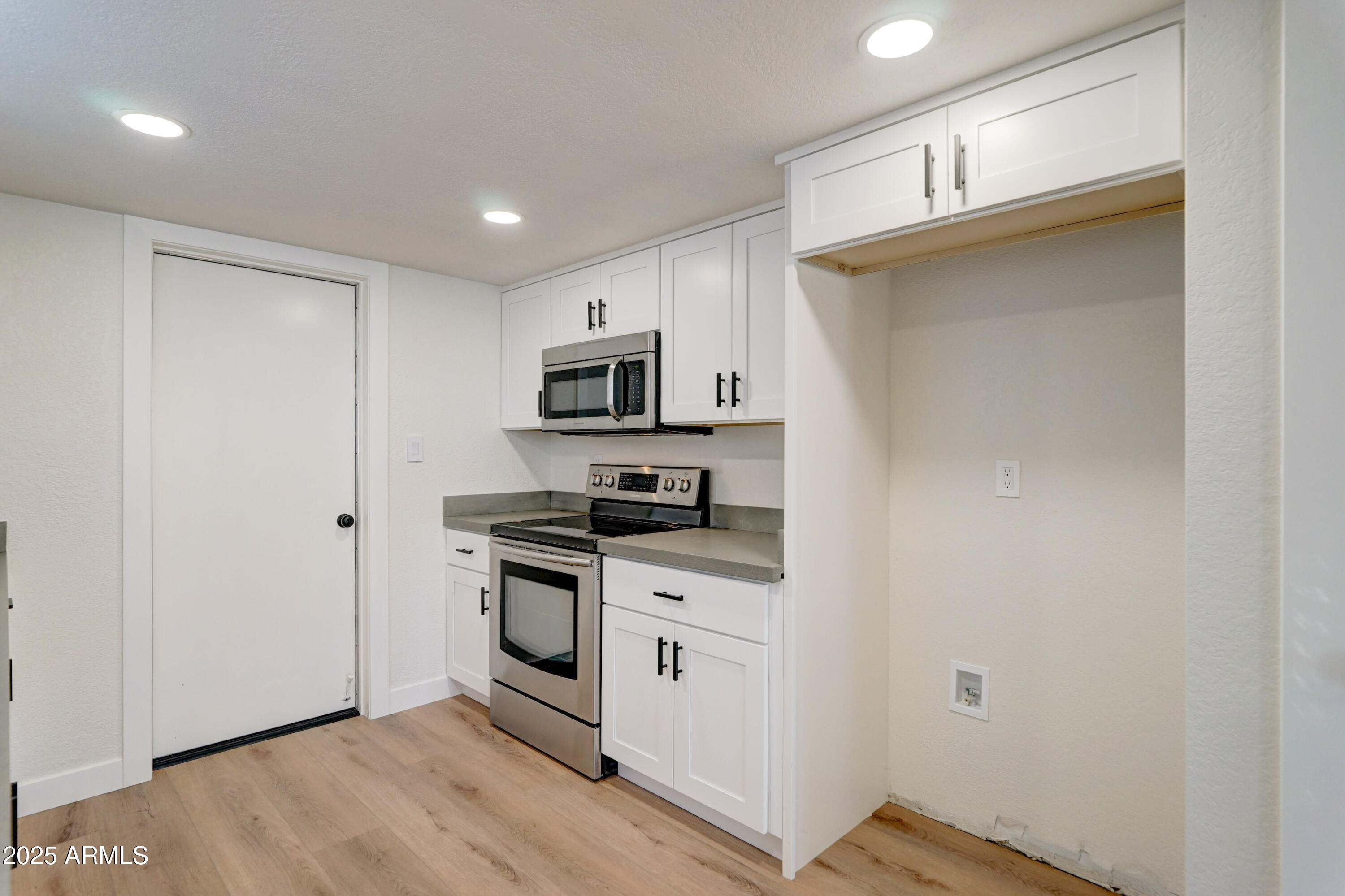 324 West Harvard Avenue Gilbert, AZ 85233 - Photo 10 of 27 a kitchen with granite countertop a sink cabinets and stainless steel appliances