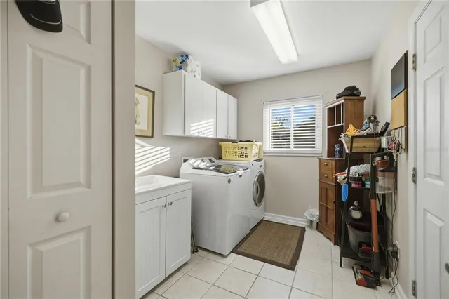 a kitchen with a refrigerator and a stove top oven