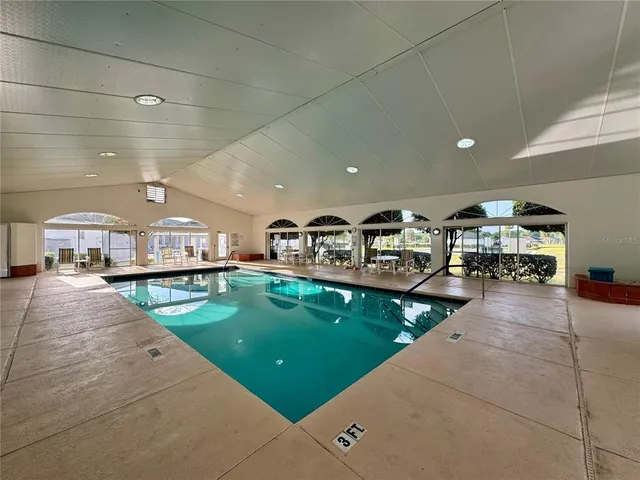 a living room with lots of chairs and a table