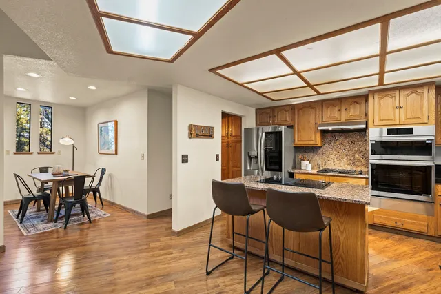 a kitchen with stainless steel appliances granite countertop a refrigerator and microwave