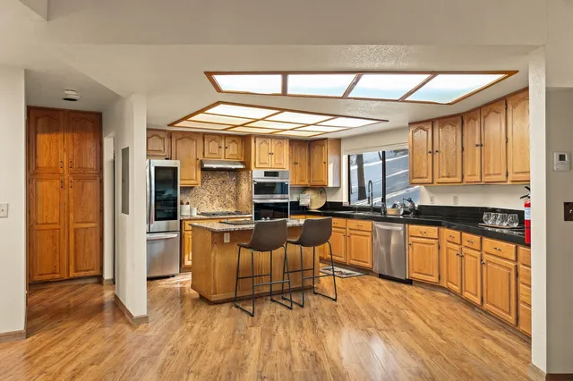 a kitchen with stainless steel appliances granite countertop a stove and refrigerator