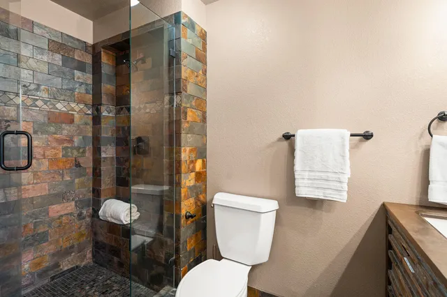 a white toilet sitting next to a bathroom sink