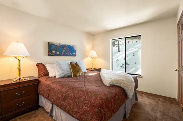 a bedroom with a bed and a night stand