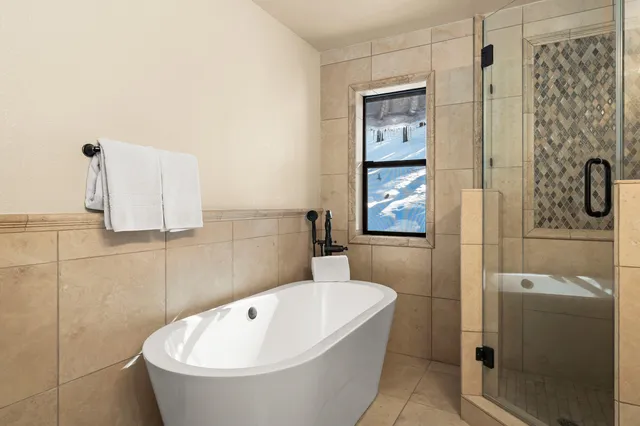 a bathroom with a bathtub and shower