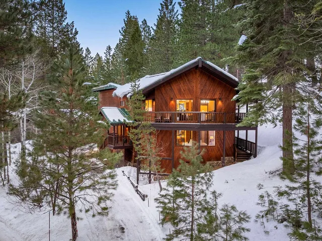 a front view of a house with yard and sitting area