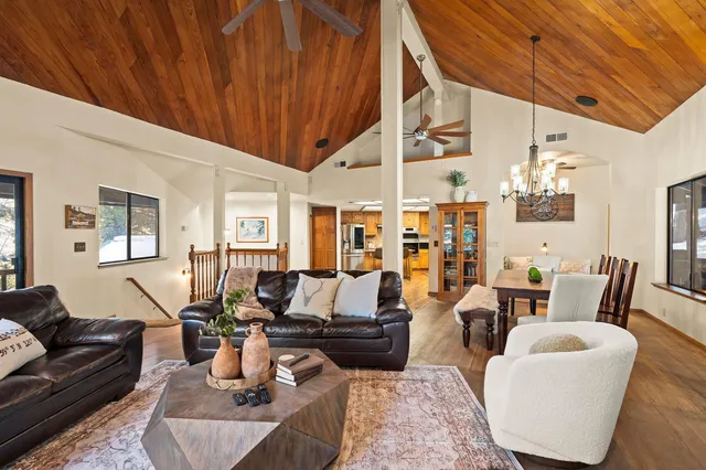 a living room with furniture a table and chairs