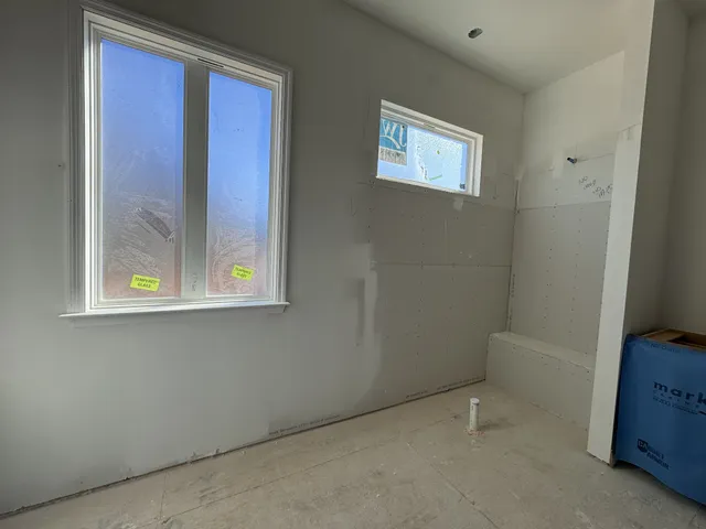 a bedroom with bed and a window