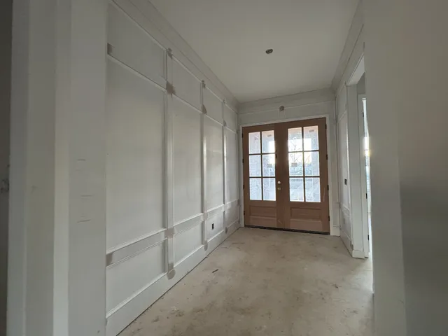 a view of an empty room with fireplace and a window