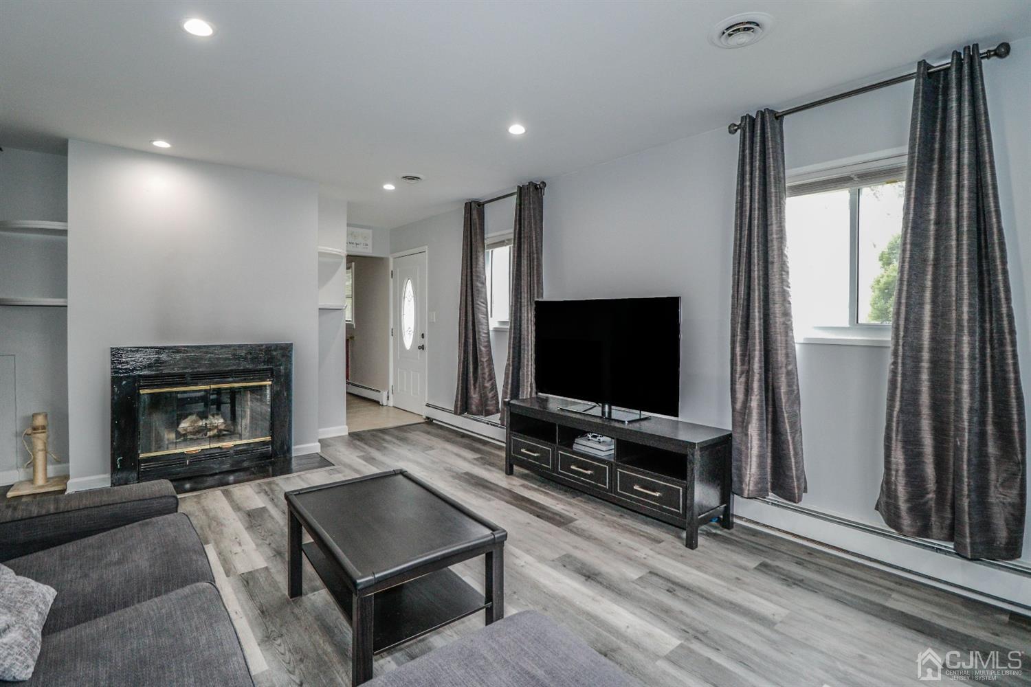 21 Kenmore Road Edison, NJ 08817 - Photo 3 of 23 a living room with furniture and a flat screen tv