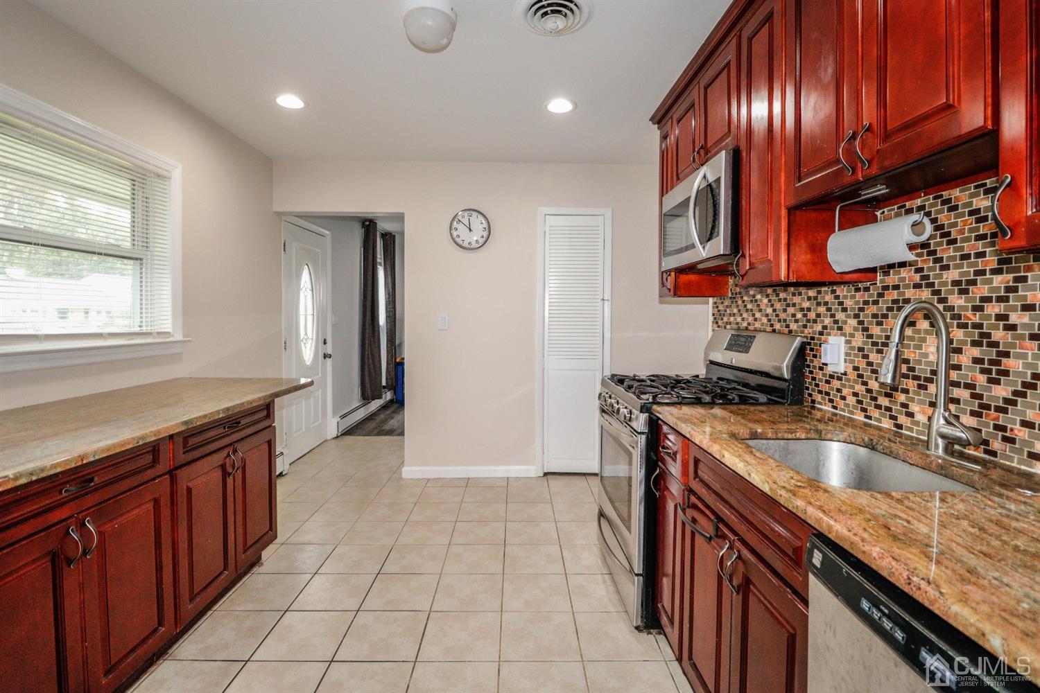 21 Kenmore Road Edison, NJ 08817 - Photo 7 of 23 a kitchen with granite countertop stainless steel appliances a sink stove top oven and cabinets