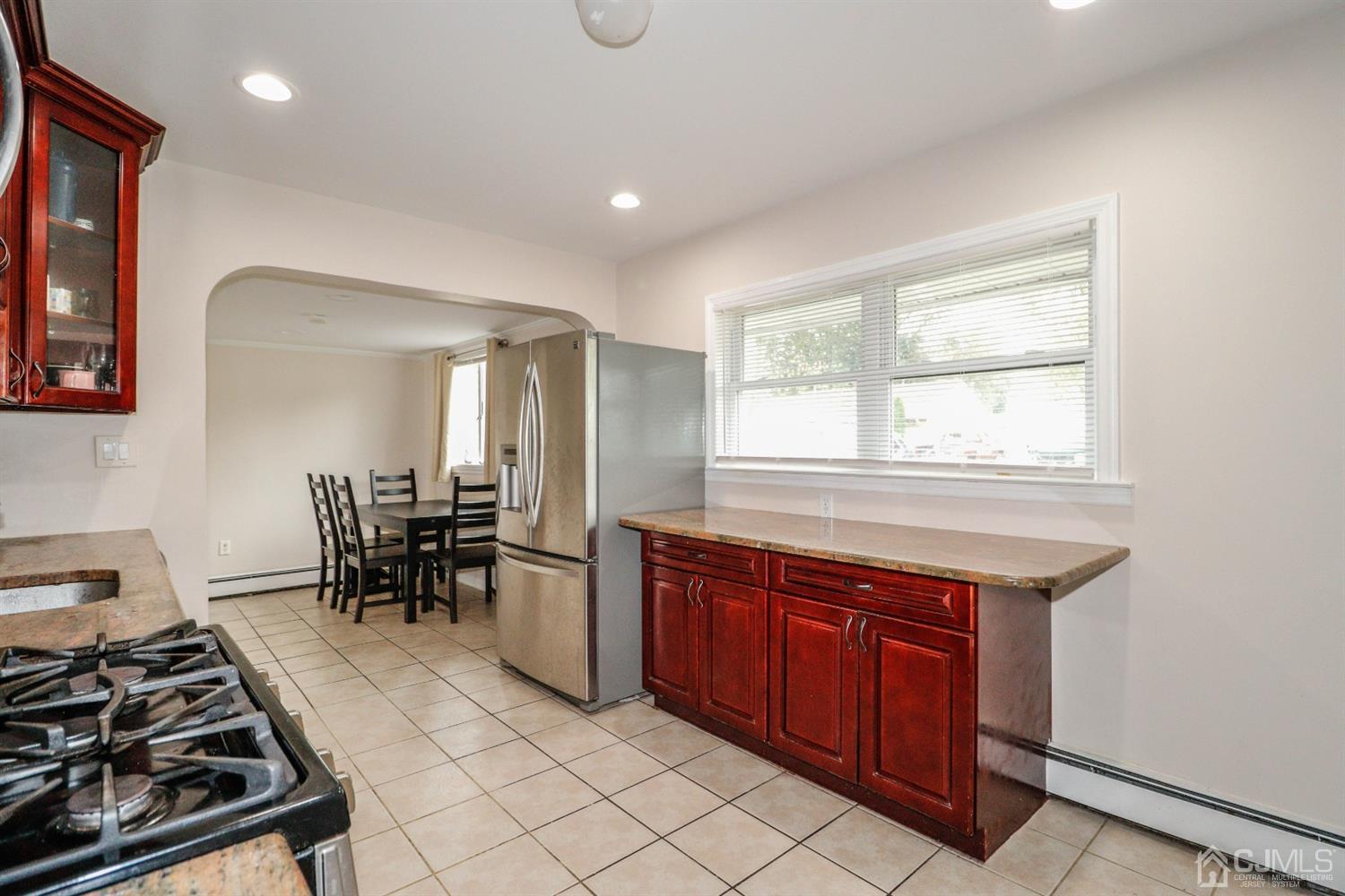 21 Kenmore Road Edison, NJ 08817 - Photo 8 of 23 a kitchen with stainless steel appliances granite countertop a stove a sink and a microwave