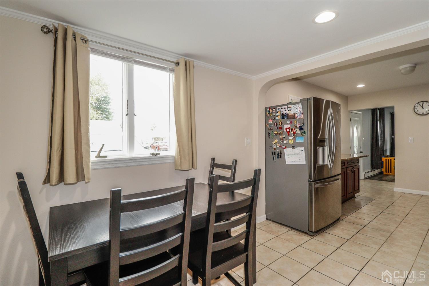 21 Kenmore Road Edison, NJ 08817 - Photo 9 of 23 a kitchen with stainless steel appliances wooden floor and dining table