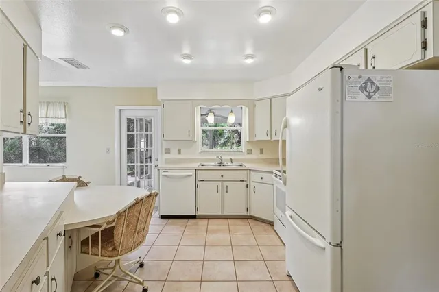 a kitchen with a sink a counter top space and stainless steel appliances