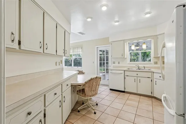 a kitchen with sink cabinets and window