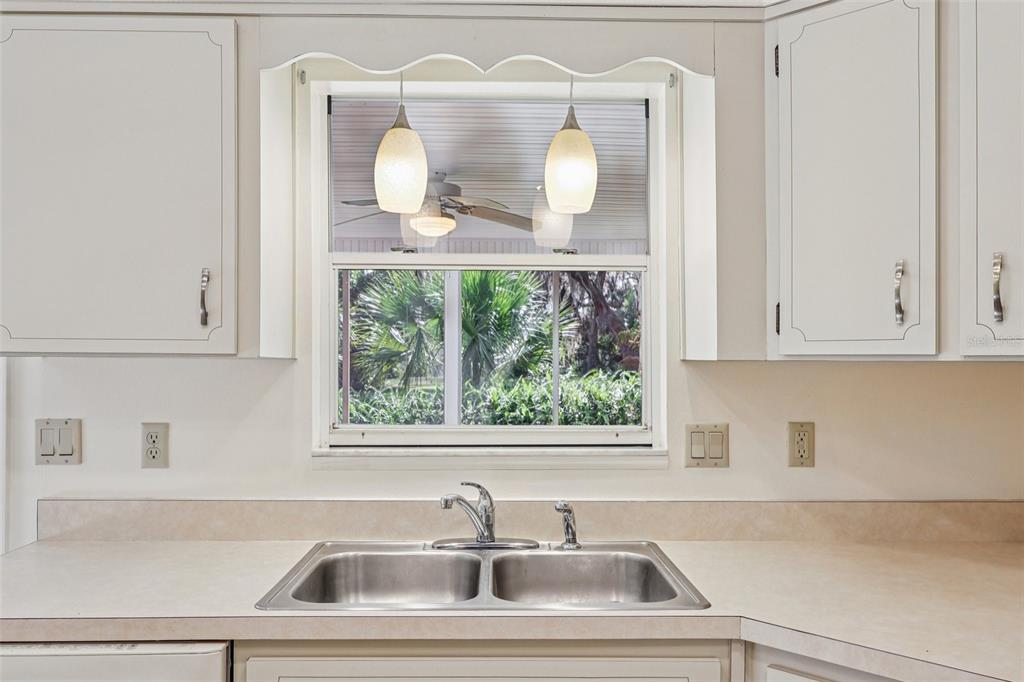 305 Brigadoon Circle Leesburg, FL 34788 - Photo 19 of 38 a bathroom with a sink and a window